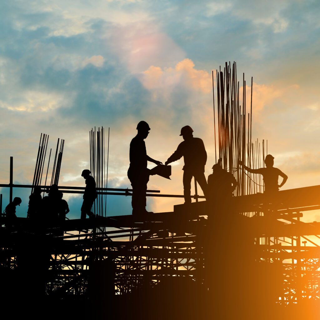 Silhouette of engineer and construction team working at site ove